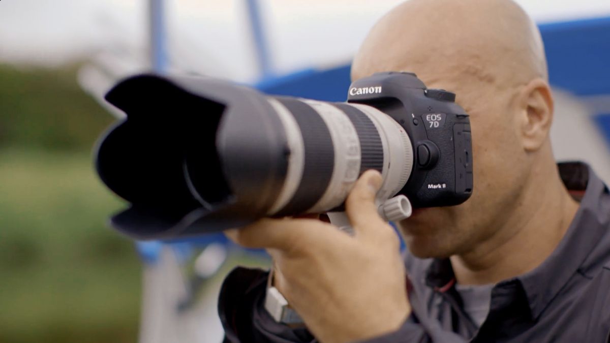 Photographer using a Canon EOS 7D Mark II outdoors